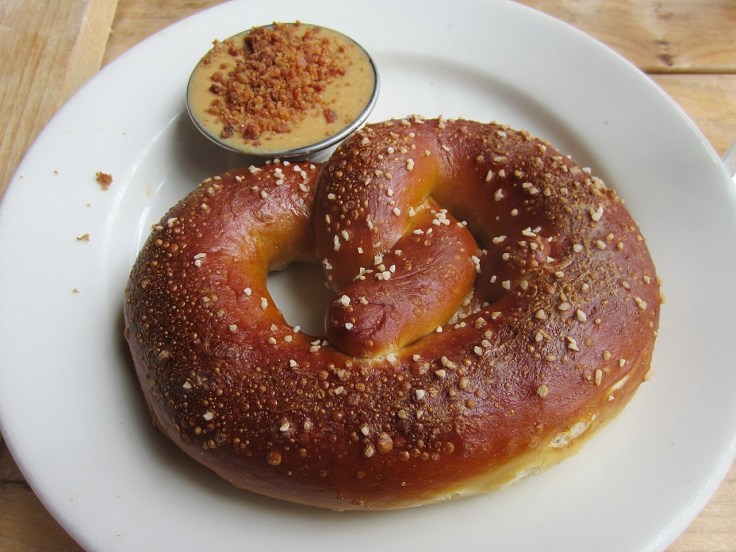 Brick oven pretzel with mustard, smoked peanut butter and bacon